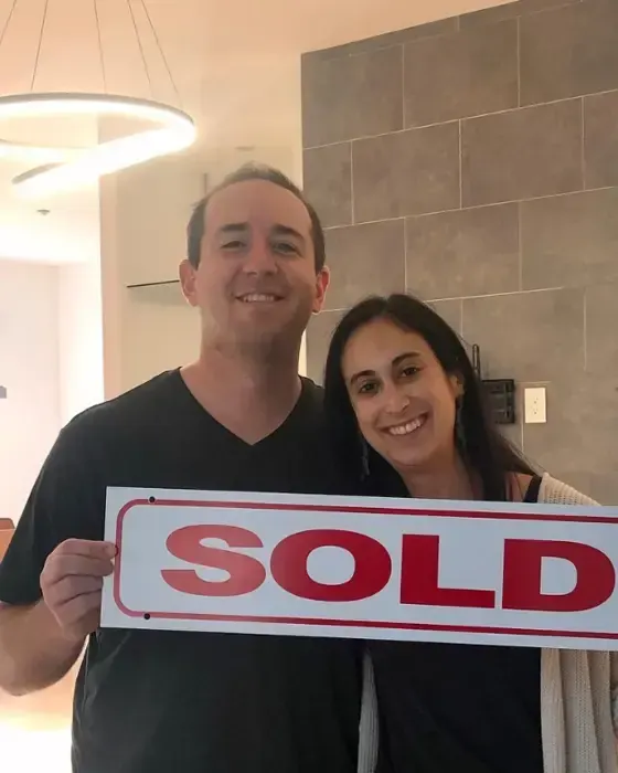 Nestor Icaza's clients holding a SOLD sign on closing day for their San Bruno or Peninsula home