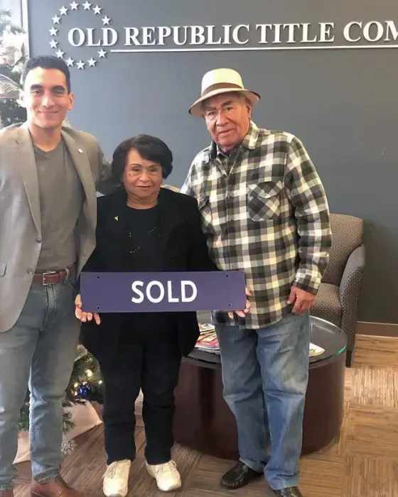 Nestor Icaza's clients holding a SOLD sign on closing day for their San Bruno or Peninsula home