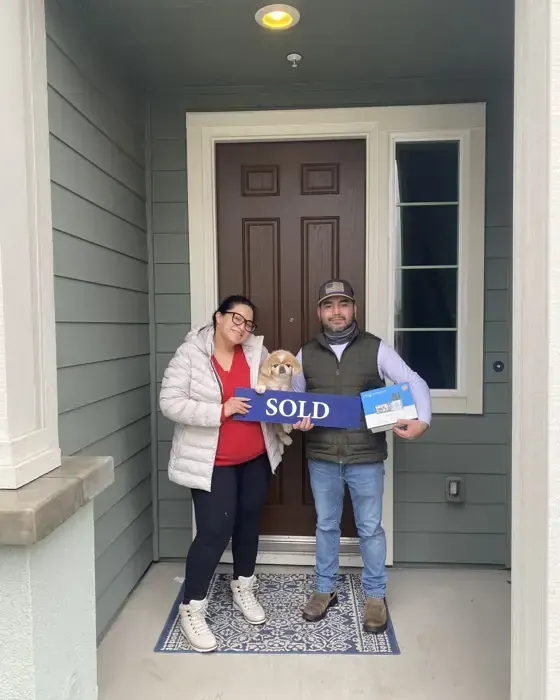 Nestor Icaza's clients holding a SOLD sign on closing day for their San Bruno or Peninsula home