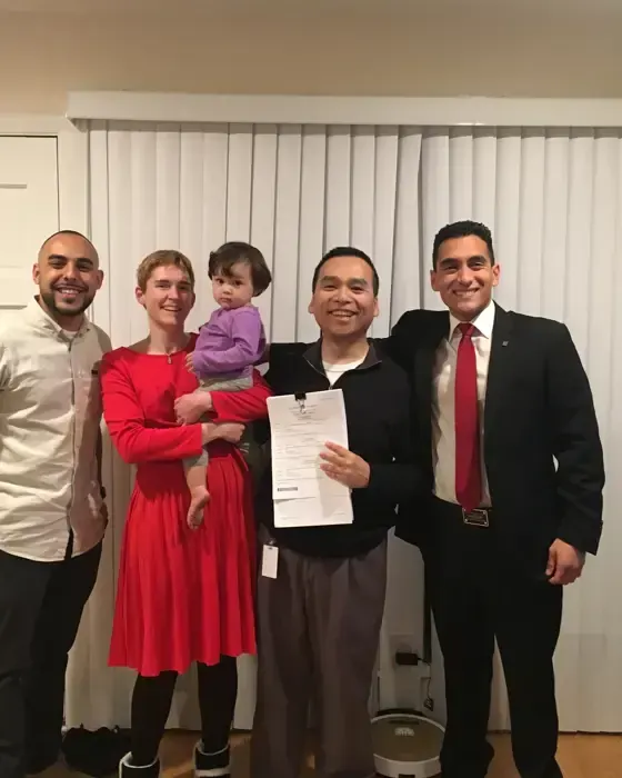 Nestor Icaza's clients holding a SOLD sign on closing day for their San Bruno or Peninsula home